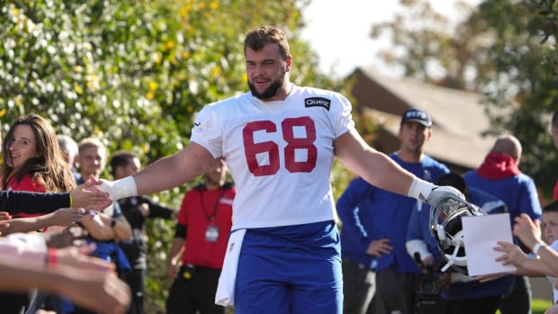 Oct 7,, 2022; Thundridge, United Kingdom; New York Giants guard Ben Bredeson (68) is greeted by children during practice at Hanbury Manor.